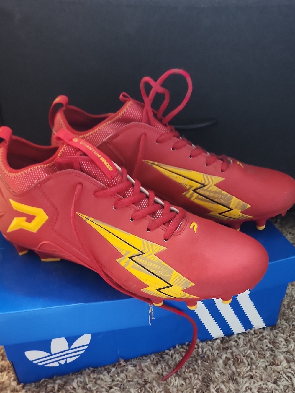 Red Athletic Soccer Cleats with Yellow Accent